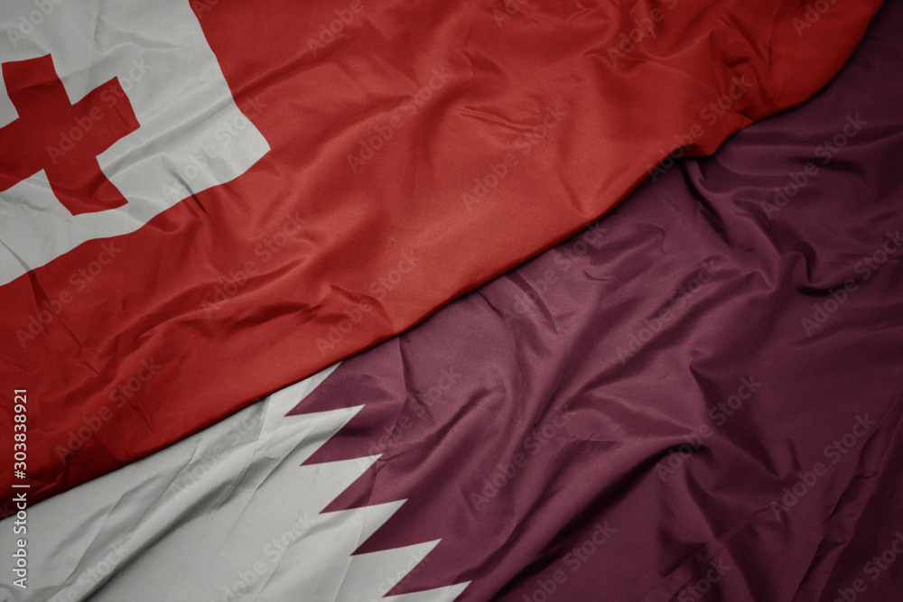waving colorful flag of qatar and national flag of Tonga . waving colorful flag of qatar and national flag of Tonga .