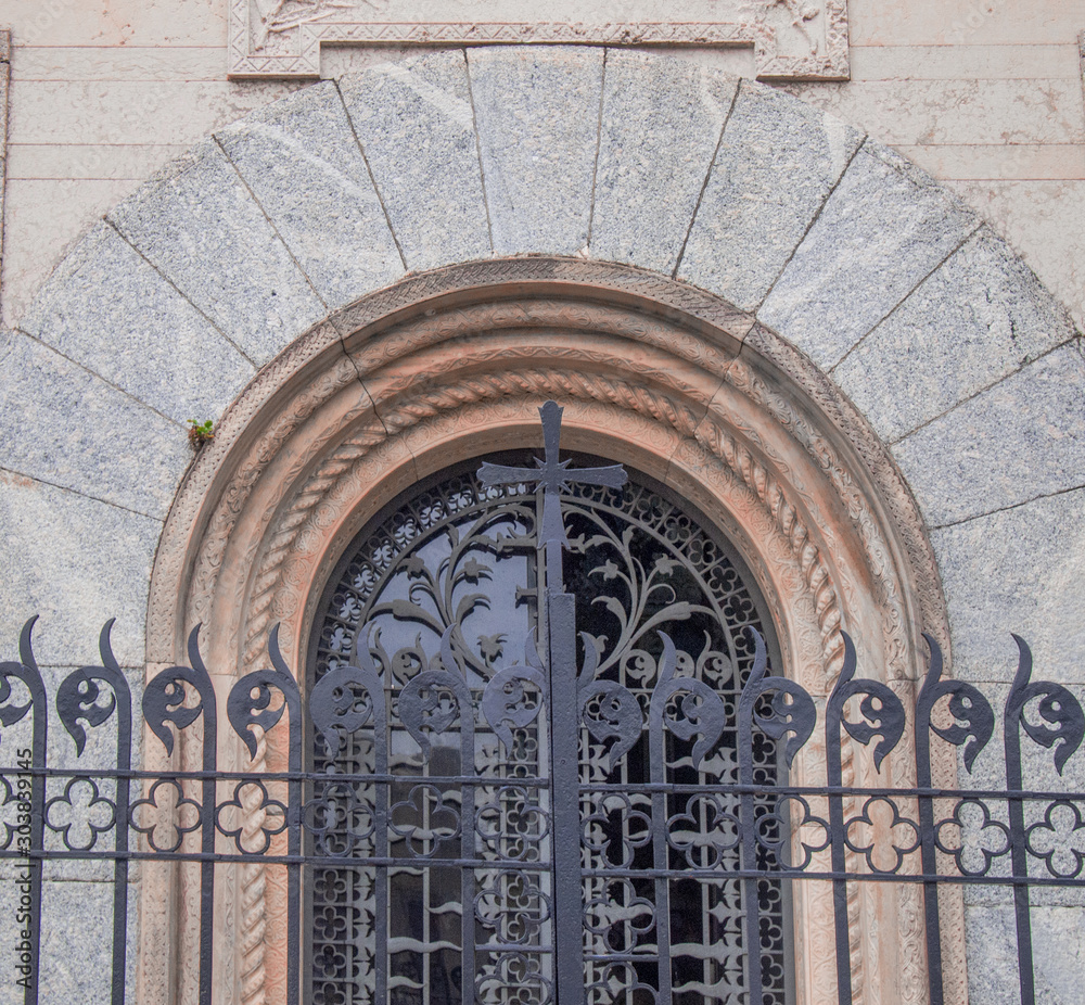 entrance door in metal finely worked in liberty style in a place of worship