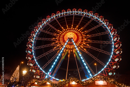 Illuminated Ferris Wheel at Christmas market in Berlin Germany