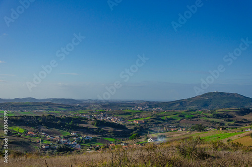 Beautiful view of the fields and city in Portugal, panorama. Sky with clouds. Place for text.