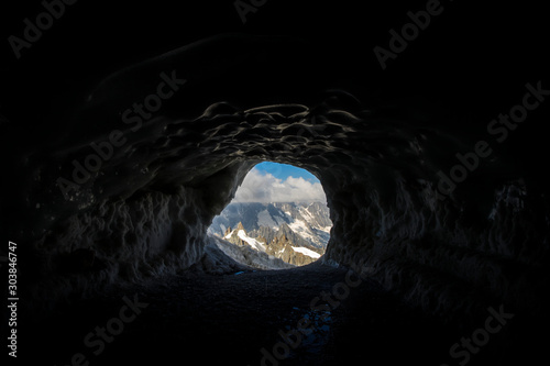 Exit tunnel of Aiguille du midi to access to the crest and the Mer de Glace, with Aiguille du Plan in the background - Chamonix, Haute-Savoie, France