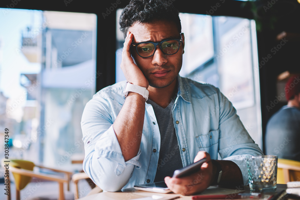 Εκτύπωση καμβά Worried hindu hipster student upset with studying problems sitting in coworking space
