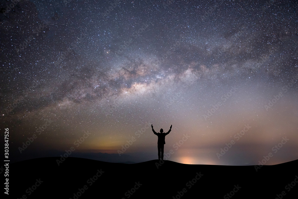 silhouette successful man on the top of the hill on a background with stars silhouette successful man on the top of the hill on a background with stars