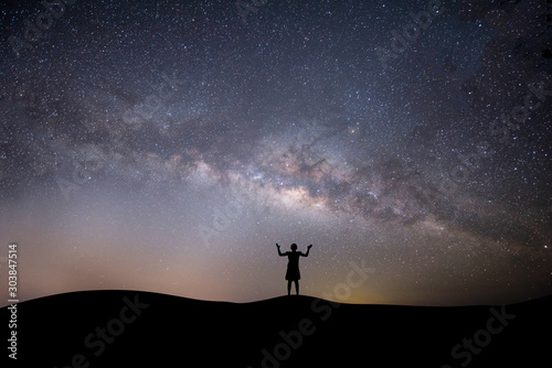 silhouette successful woman on the top of the hill on a background with stars