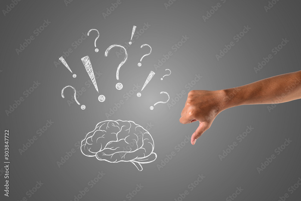 The brain with many questions painted in white chalk and The thumb pointing down, draw concept. The brain with many questions painted in white chalk and The thumb pointing down, draw concept.