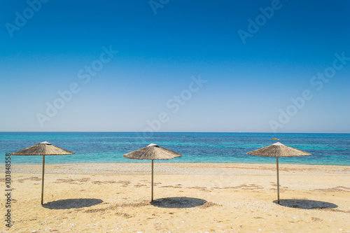 Umbrellas made of natural wood on the beach