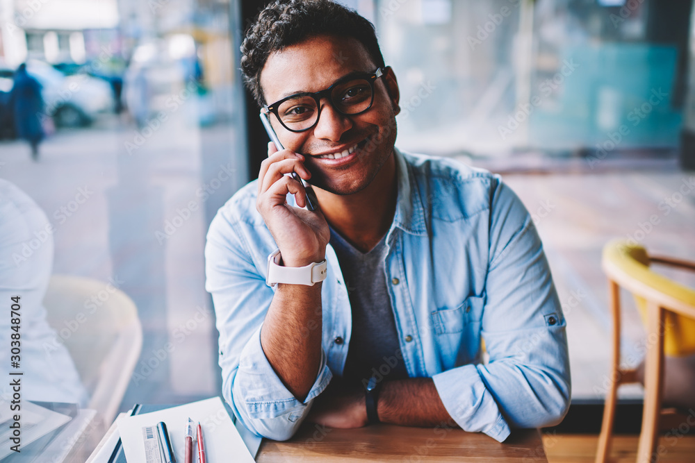 Φωτογραφία Half length portrait of mature handsome successful businessman in spectacles talking on mobile phone indoors