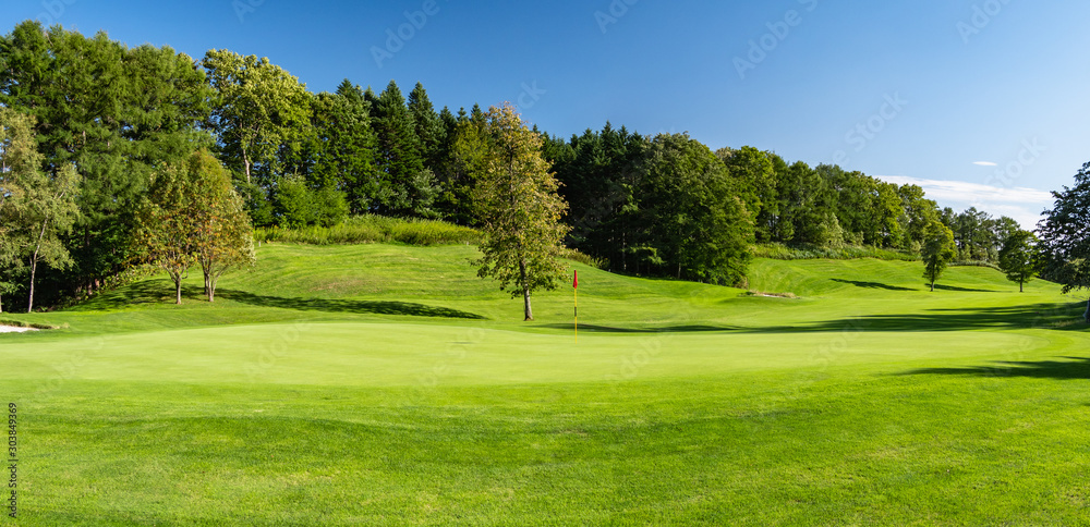 Panorama View of Golf Course with beautiful putting green. Golf course with a rich green turf beautiful scenery.