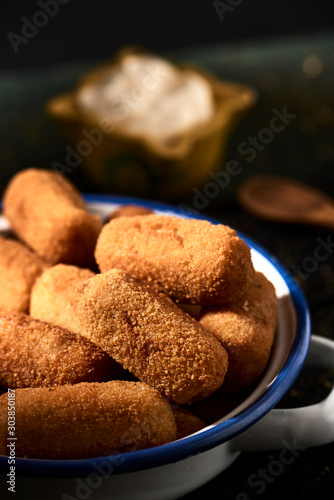 spanish croquettes on a rustic wooden table photo