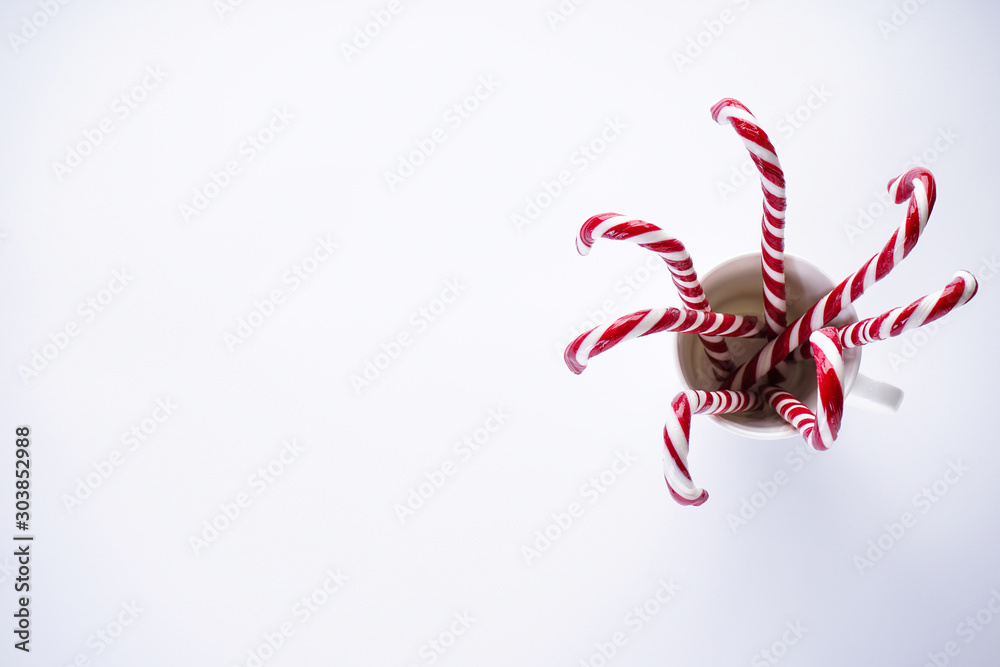 Christmas concept. Christmas candies in a white ceramic cup, on a white background. Place for text, flat lay. Christmas concept. Christmas candies in a white ceramic cup, on a white background. Place for text, flat lay.