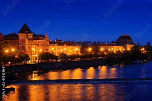 Vltava river in night, Prague in Czech Republic. Twilight view of Prague with rose-orange sky, Smetanovo nabrezi, Prague, travelling in Europe photo
