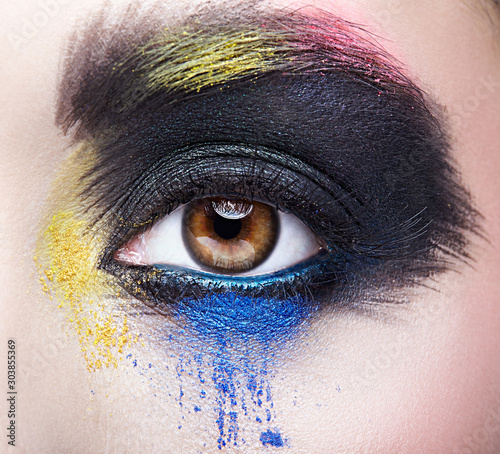 Female eye with unusual artistic painting makeup