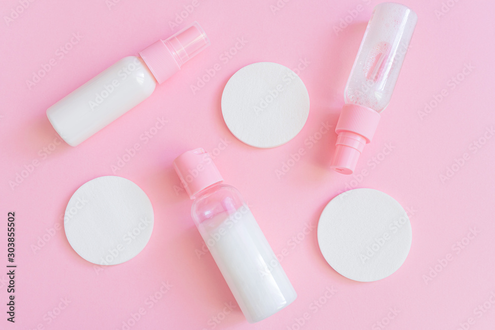 Cosmetic sponges and a bottle with gel on a pink background. The concept of face and body skin care, cosmetology. Minimalism, top view. Copyspace Cosmetic sponges and a bottle with gel on a pink background. The concept of face and body skin care, cosmetology. Minimalism, top view. Copyspace
