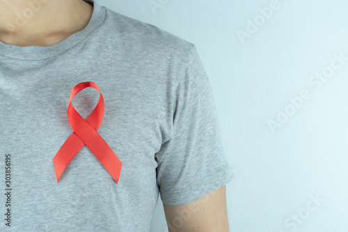 Aids awareness, red ribbon on the man chest. World Aids Day, Healthcare and medical concept.