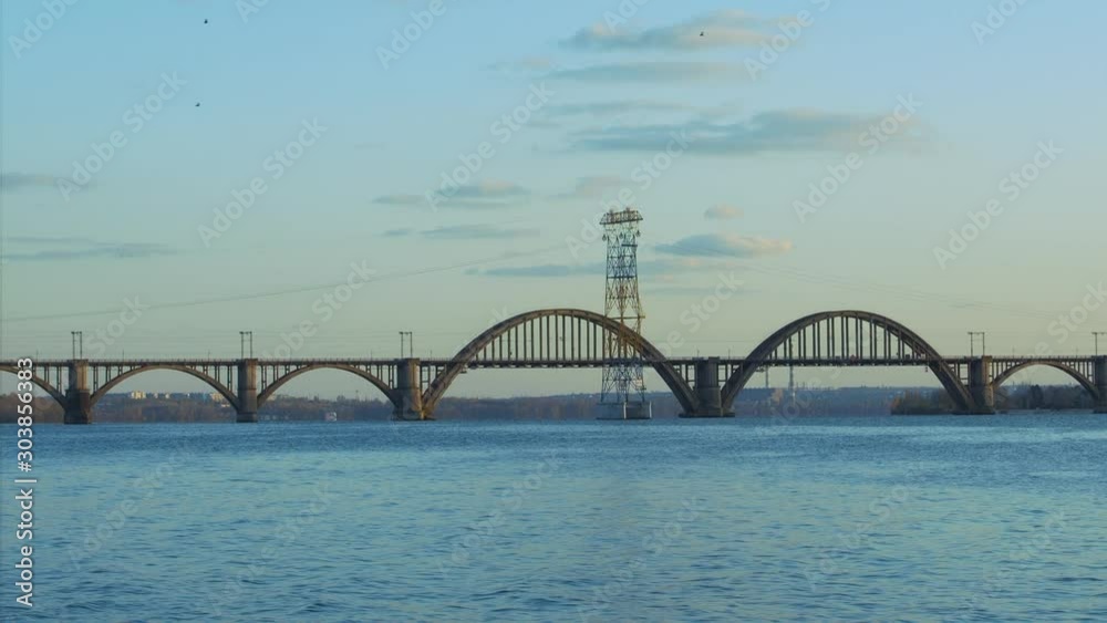 Merefo-Kherson railway Bridge on the Dnieper River in Dnepropetrovsk (Dnieper) at sunset, Ukraine Merefo-Kherson railway Bridge on the Dnieper River in Dnepropetrovsk (Dnieper) at sunset, Ukraine