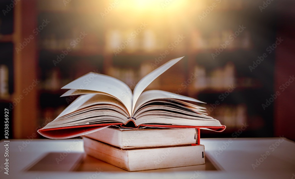 The blurred book that is bewitched with magic, the magic light in the dark, with the bright light shining down as the power to search for knowledge. For research and use as a blurred background