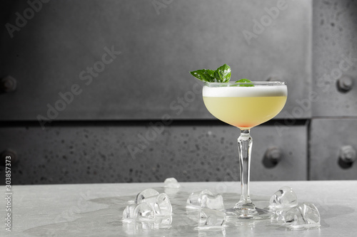 Obraz na płótnie Homemade Pisco sour cocktail. Whiskey Sour in Coupe Glass with ice on gray background. Overhead view, copy space. Advertising for cafe. Bar menu. Horizontal photo. w salonie