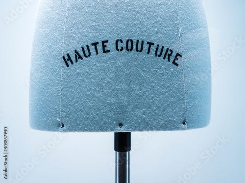 Haute Couture signage on mannequin made from fine luxury garment textile in luxury fashion store atelier photo