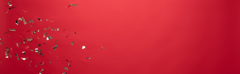 view of golden christmas confetti isolated on red with copy space