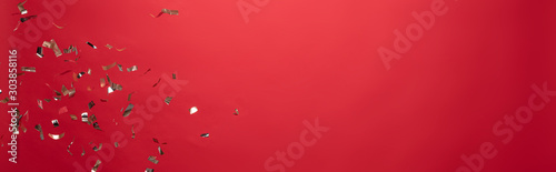 view of golden christmas confetti isolated on red with copy space