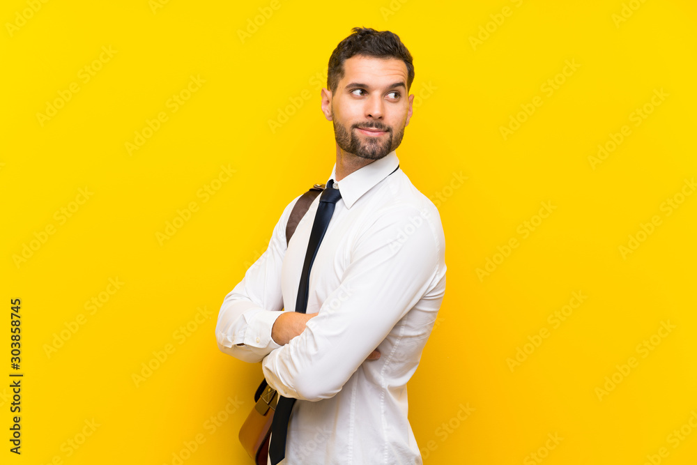 Handsome businessman over isolated yellow background laughing Handsome businessman over isolated yellow background laughing