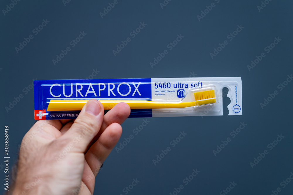 Paris, France - Oct 10, 2019: Man hand holding Curaprox 5460 ultra soft  Swiss premium toothbrush against gray background Stock Photo | Adobe Stock