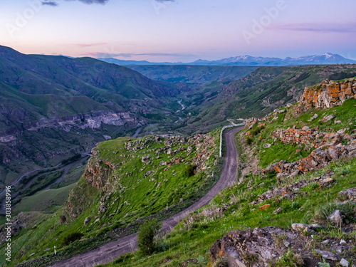 Beautiful Caucasus landscape with dirt road winding through mountains