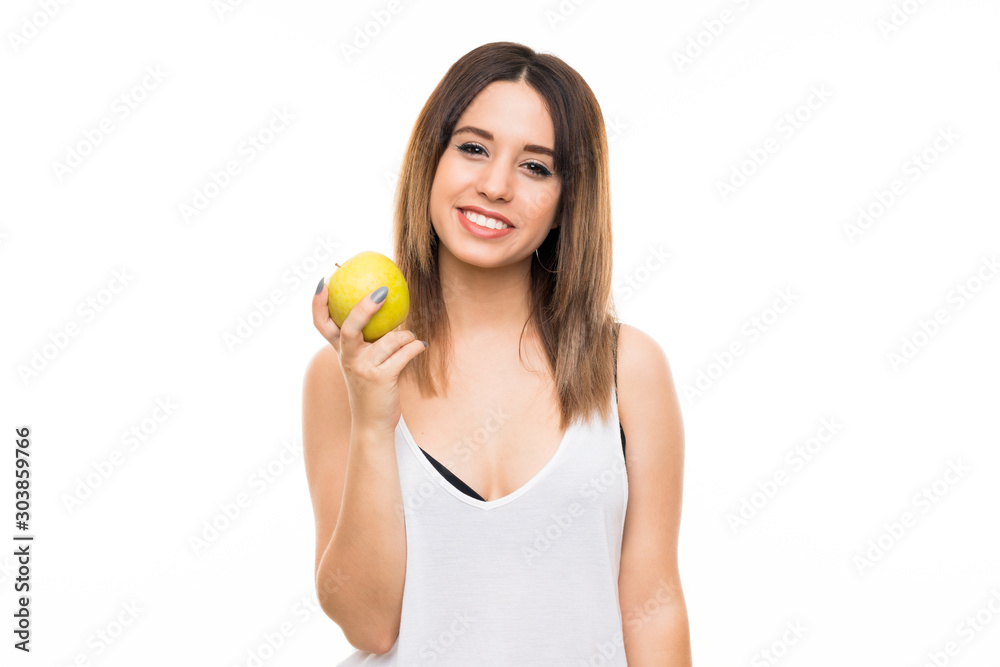 Young woman over isolated white background with an apple Young woman over isolated white background with an apple