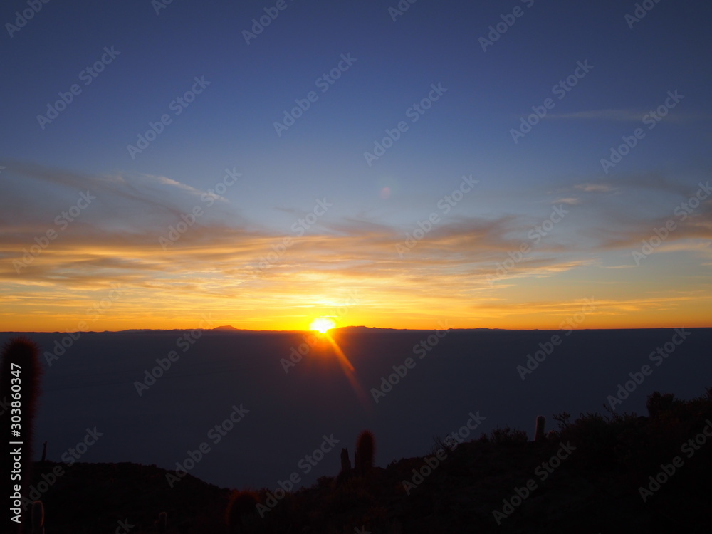 Spectacular sunrise from the top of Isla Incahuasi, Isla Incahuasi is an island in a sea of salt covered with giant Trichocereus cacti, Uyuni salt lake (Salar de Uyuni), Uyuni, Bolivia Spectacular sunrise from the top of Isla Incahuasi, Isla Incahuasi is an island in a sea of salt covered with giant Trichocereus cacti, Uyuni salt lake (Salar de Uyuni), Uyuni, Bolivia
