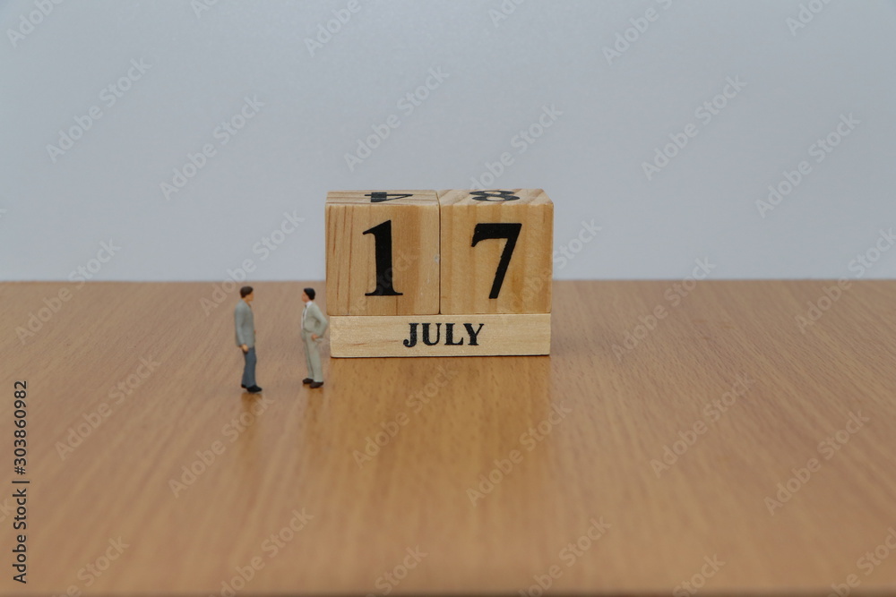 July 17, a calendar photo from the wood The table top consists of a book and pen that is ready to use. White background July 17, a calendar photo from the wood The table top consists of a book and pen that is ready to use. White background