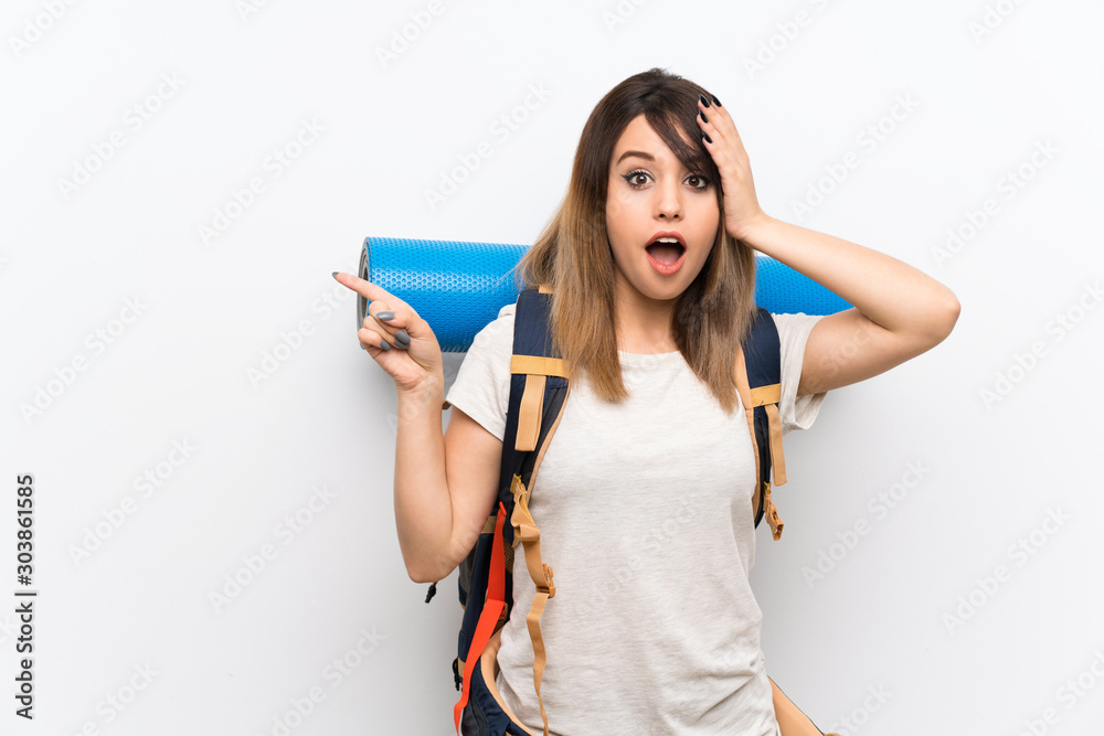 Young traveler woman over white background surprised and pointing finger to the side Young traveler woman over white background surprised and pointing finger to the side