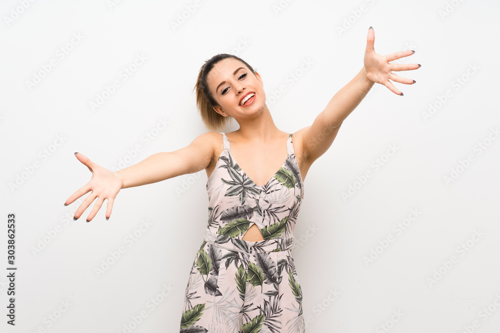 Young woman over isolated white background presenting and inviting to come with hand Young woman over isolated white background presenting and inviting to come with hand