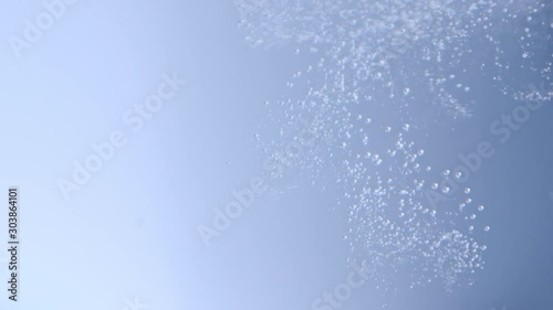 Wallpaper Mural Sparkling powder poured into water, creating beady bubbles. 240fps slowmotion. Torontodigital.ca