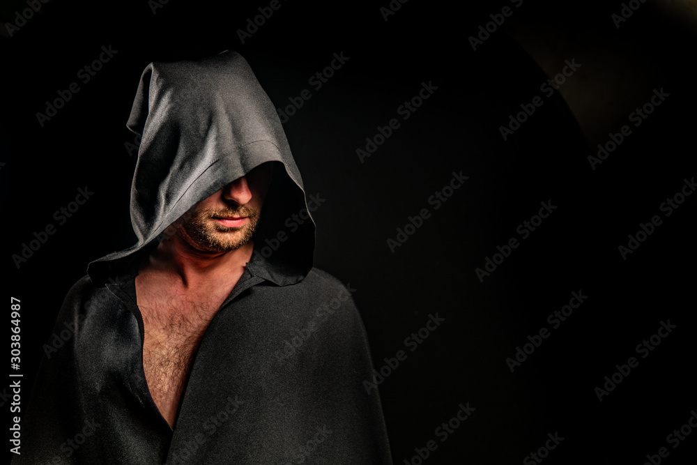 Portrait of a courageous warrior wanderer in a black cloak. Historical fantasy. Halloween Portrait of a courageous warrior wanderer in a black cloak. Historical fantasy. Halloween