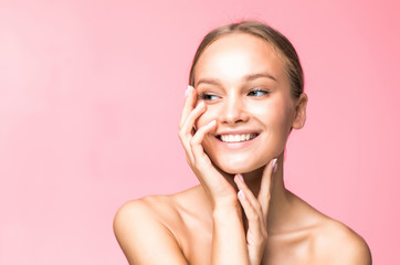 Woman body skin care. Beautiful young female touching smooth soft skin on pink background. Spa and cosmetics concept.
