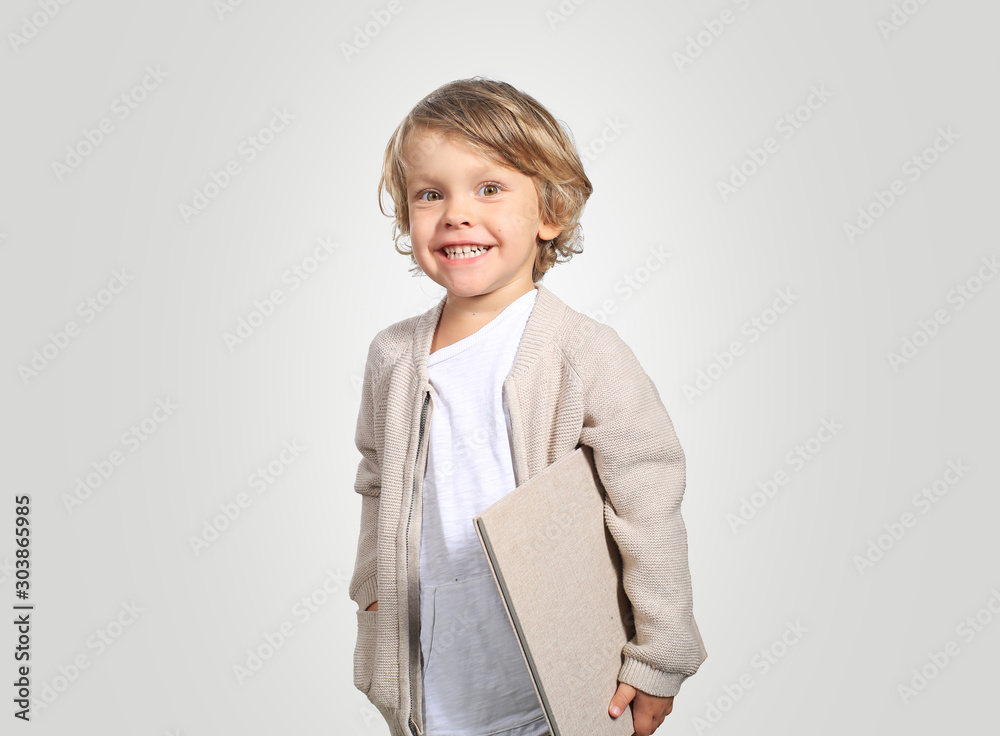 Very cute little boy with a book in his cardigan Very cute little boy with a book in his cardigan