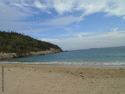 Rocky Maine Coast with the Atlantic Ocean reflecting off the water as it washes ashore
