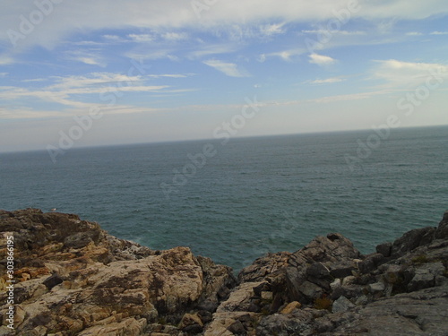 Rocky Maine Coast with the Atlantic Ocean reflecting off the water as it washes ashore