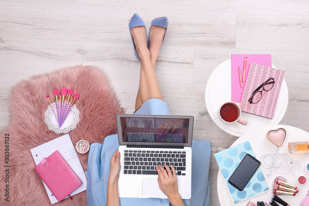 Εκτύπωση καμβά Beauty blogger with laptop and cosmetics sitting on floor, top view