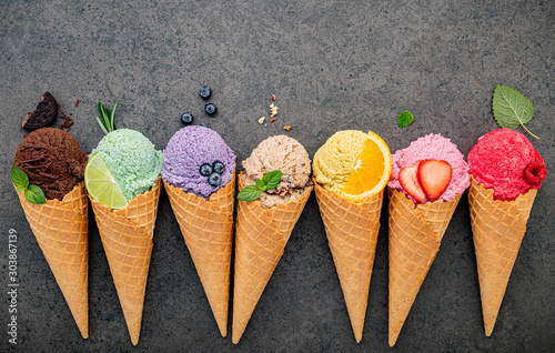 Flat lay ice cream cones collection on dark stone background . Blank crispy ice cream cone with copy space for sweets menu design.