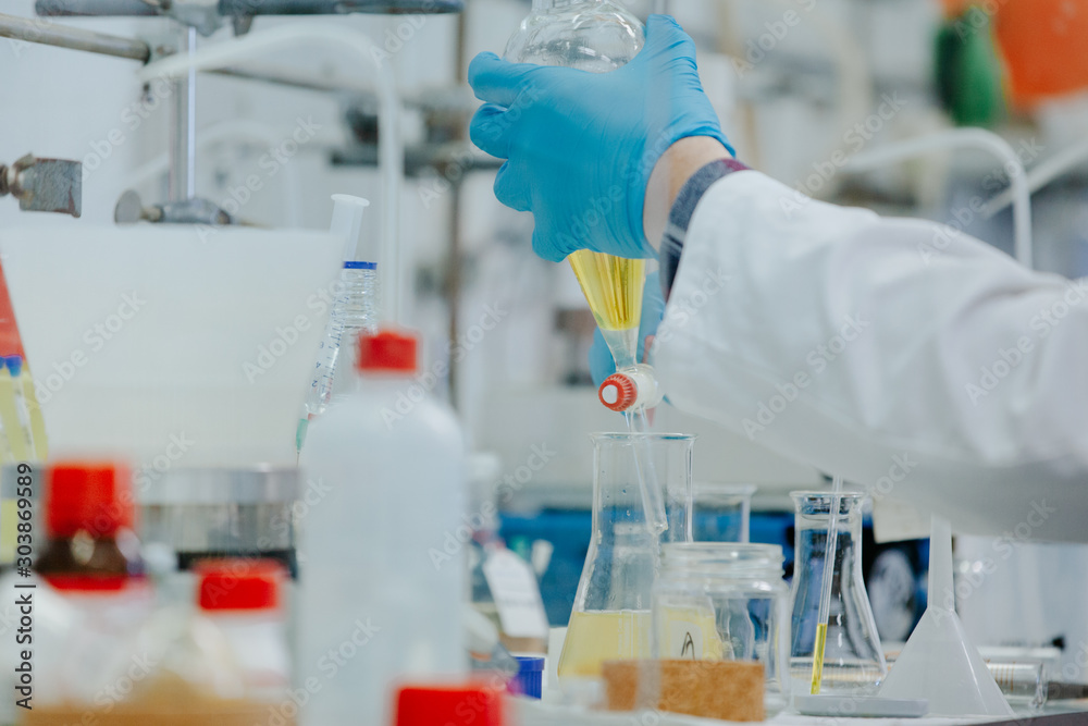 A busy desk at a chemistry lab. A scientific experiment being conducted in the laboratory. A busy desk at a chemistry lab. A scientific experiment being conducted in the laboratory.