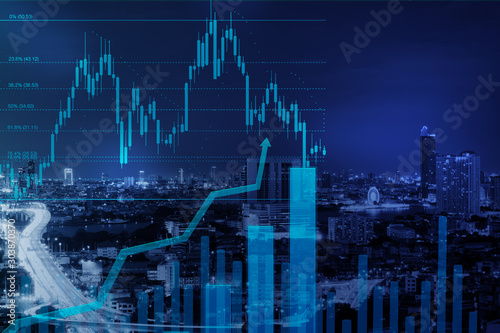 stock graph with fibonacci indicator with volume diagram growth up and city scape night view on background with copyspace for text