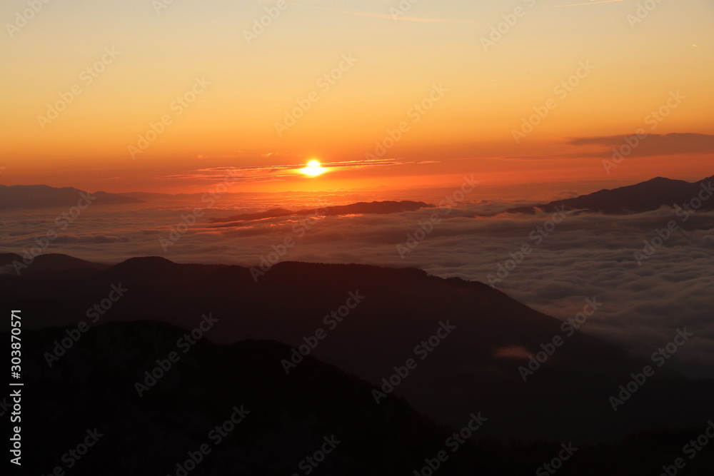 Morning fog in Bohinj valley with sunrise