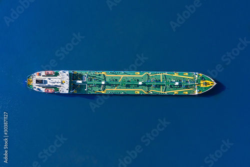 Aerial view tanker ship with liquid bulk cargo is sailing in blue water. © aapsky