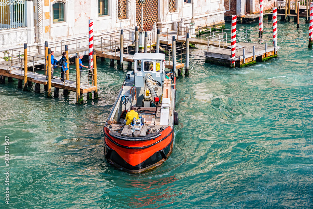 Working boat on Venetian canal in Venice, Italy
