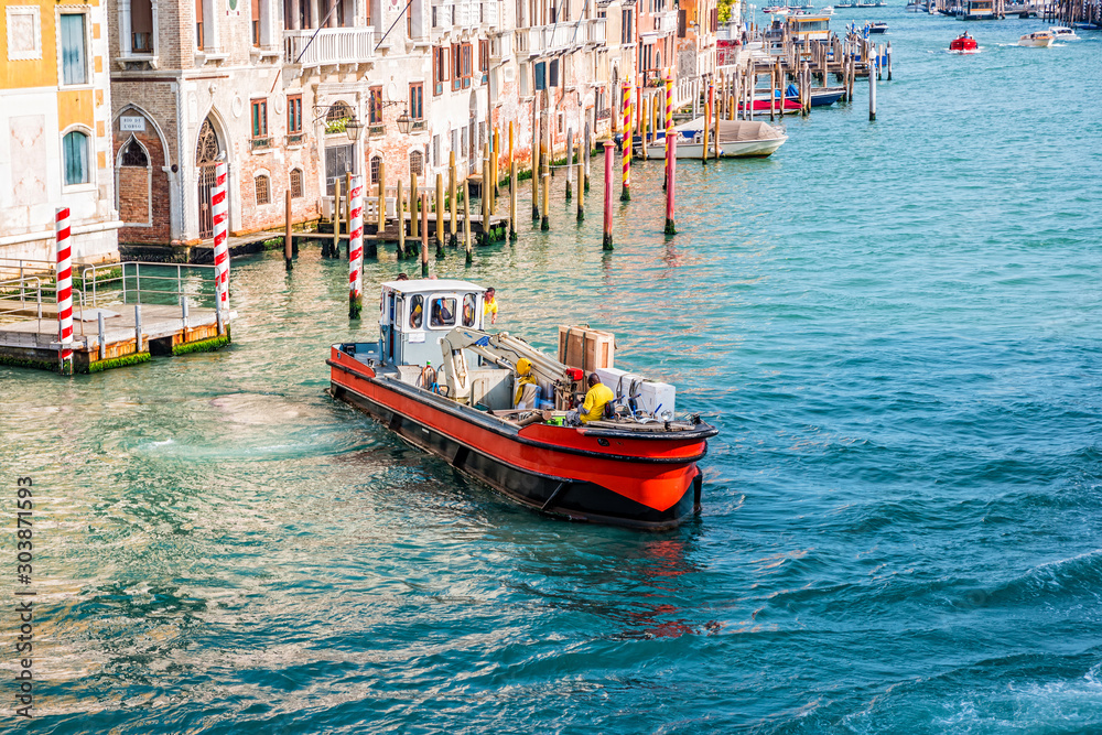 Working boat on Venetian canal in Venice, Italy