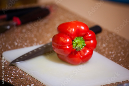  fresh juicy red sweet organic peppers on a cutting board, cooking veggie food