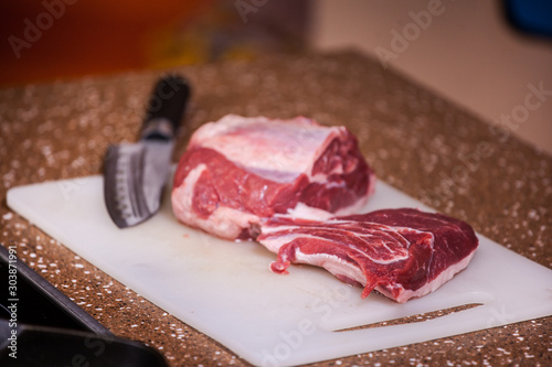 fresh meat for steak on a cutting board