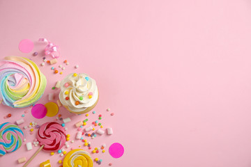 Flat lay composition with cupcake on pink background, space for text. Birthday party