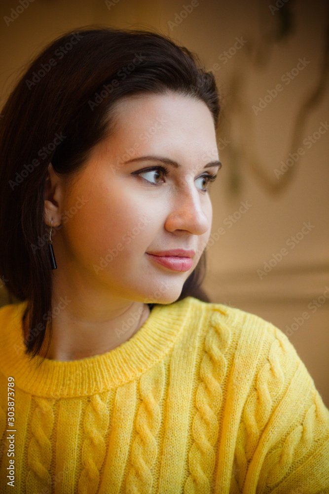 portrait of a girl in a yellow knitted sweater portrait of a girl in a yellow knitted sweater